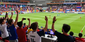 Fans enjoying koora live match in a vibrant stadium atmosphere.